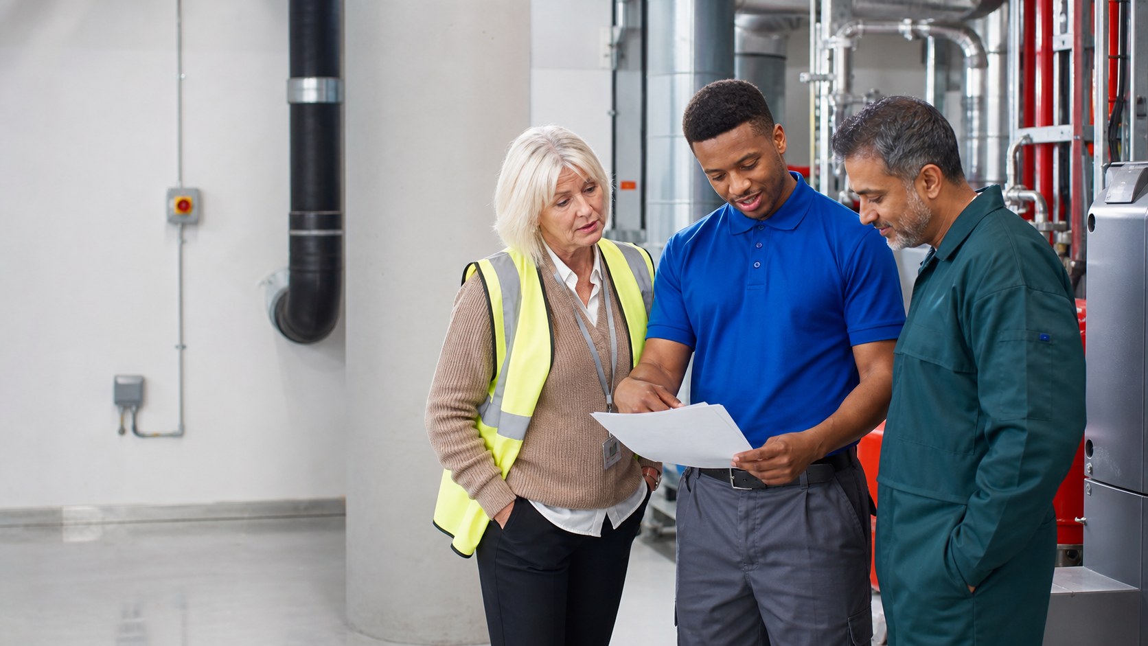 A varied facilities team reviewing completed work in a commercial building.