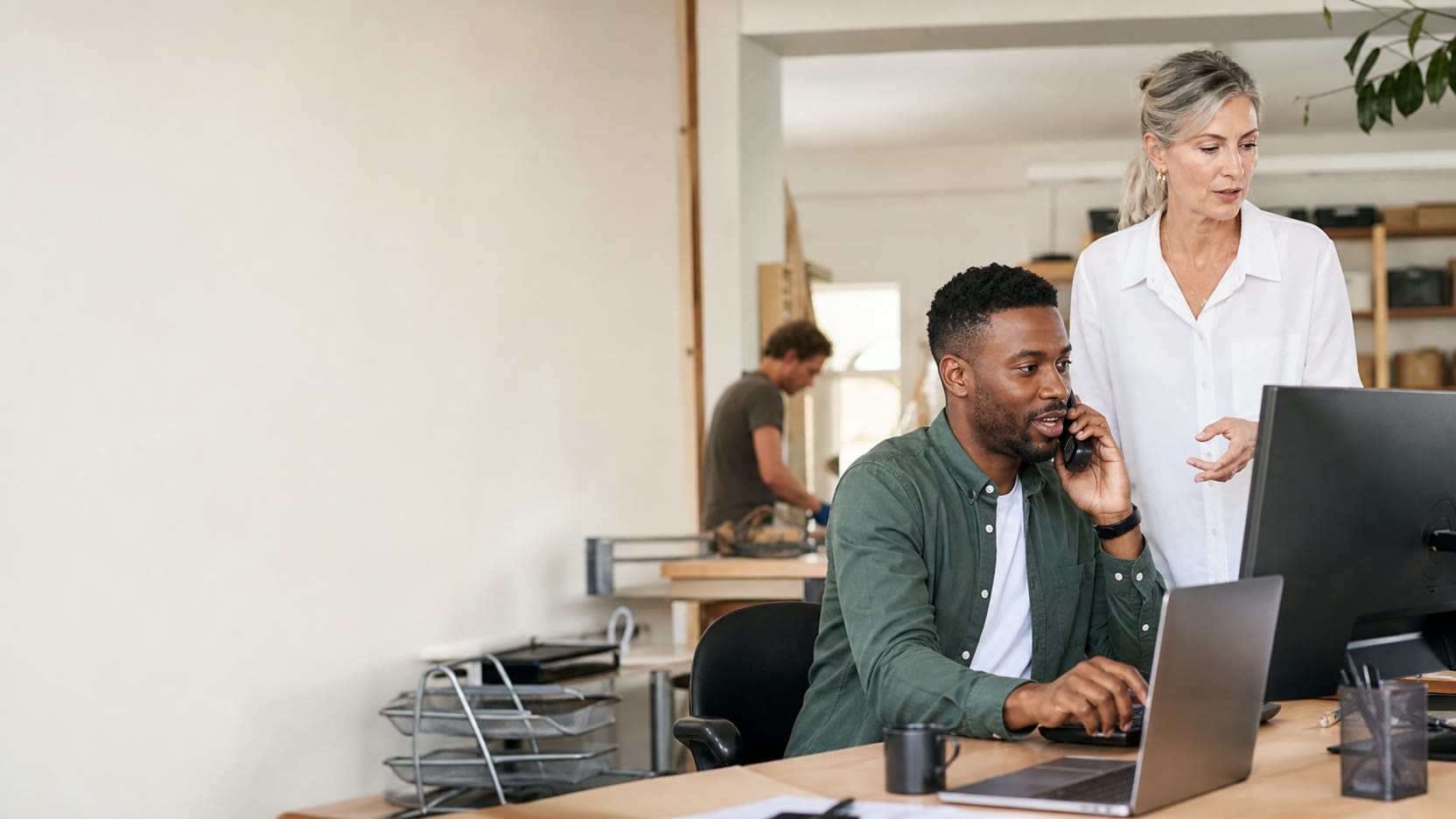 A service business office team handling customer conversations from phone and desktop.