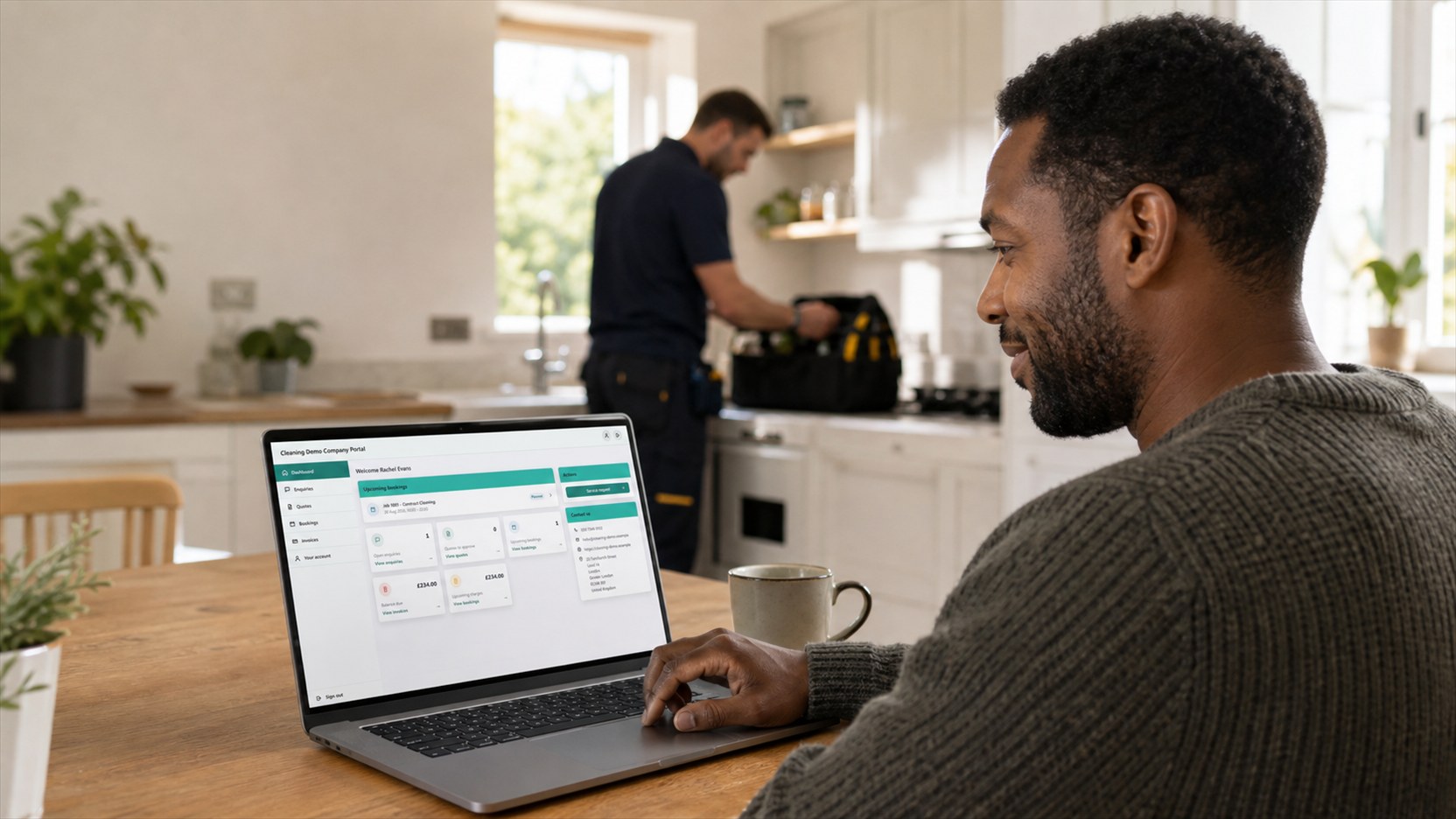 A customer using the JobTek customer portal at home while an engineer completes service work nearby.