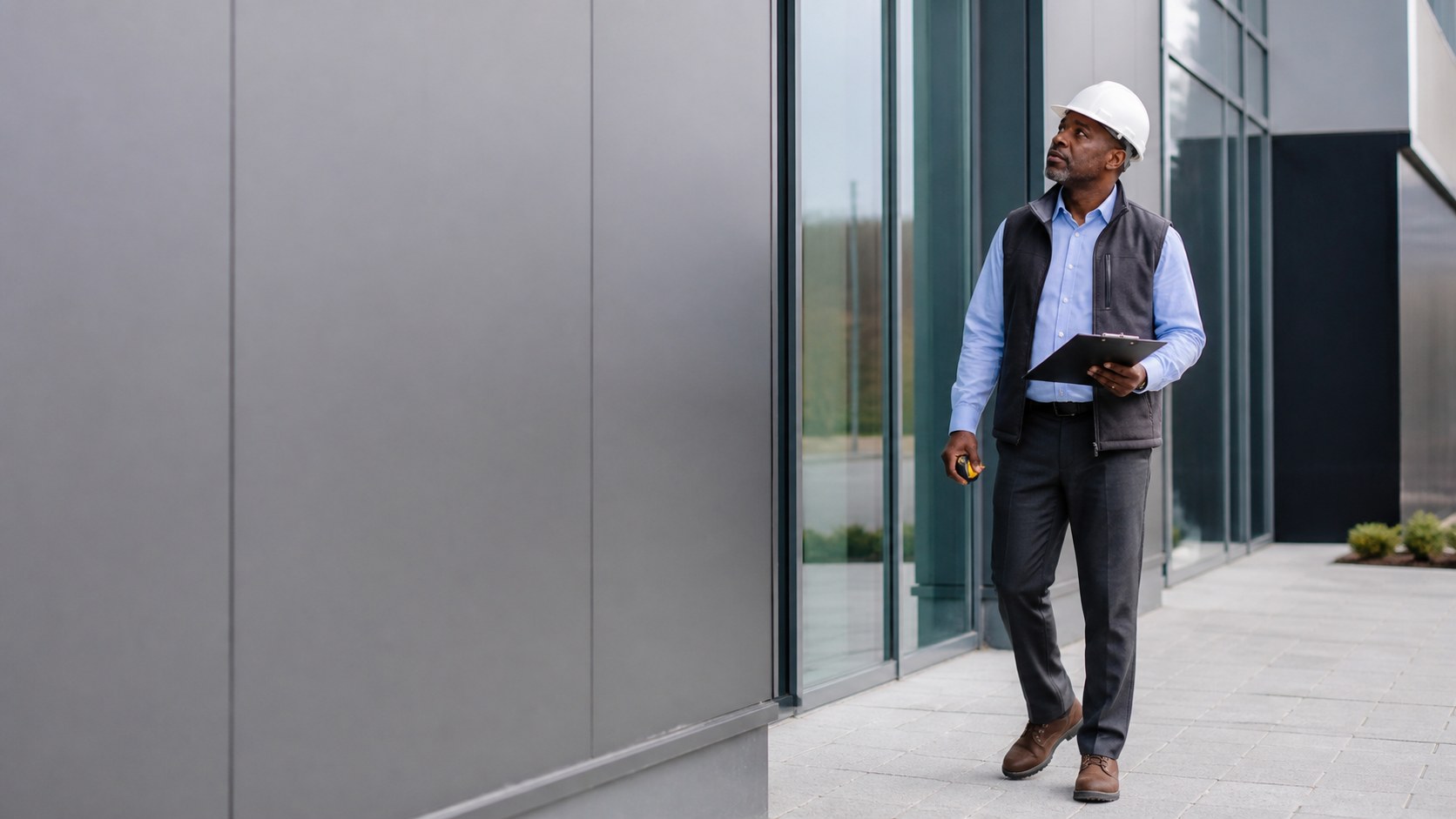 An experienced building surveyor inspecting a commercial property.